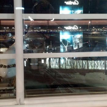 View through a window - Cartier store reflected in the glass, and planes behind.